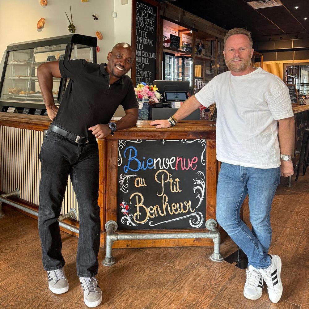 Fabrice Carreau with the owner of Au P’tit Bonheur, at the café counter in Bradenton